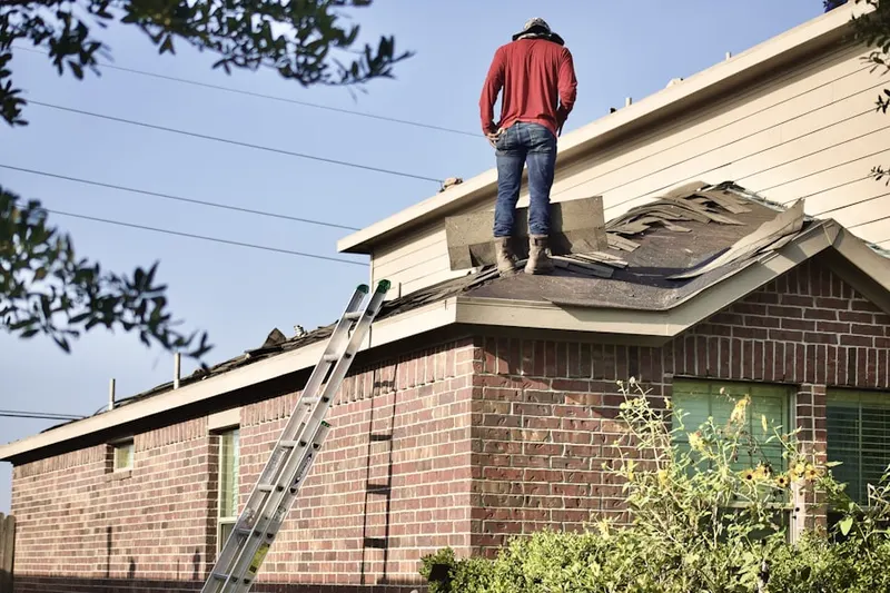 Professional roofer working on a residential roof in Sarasota